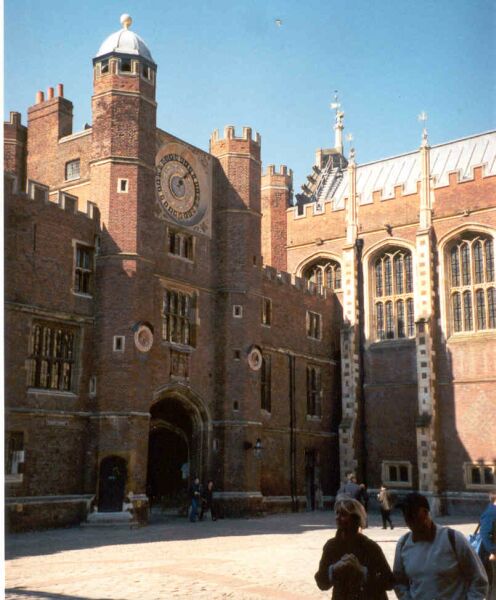The interior courtyard of Hampton Court Palace, with a twenty four hour clock above the doorway.
