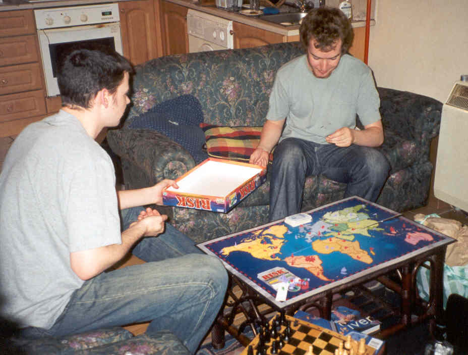 A late night session of Risk at Andy and Mal's, with some typical sights: the bottle of JD in the corner, Mal (on the left) and his Red Army about to sweep over the board and knock what little remains of Andy's purple forces off the board. Also, notice the chess board set up, since Andy takes so long for his move that Mal and I typically can play a game or two between our goes.